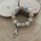 Porte-clés bracelet perlé beige & blanc – Motifs floraux dorés Ma boutique