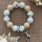 Porte-clés bracelet perlé beige & blanc – Motifs floraux dorés Ma boutique