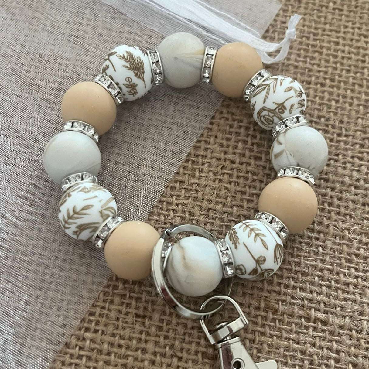 Porte-clés bracelet perlé beige & blanc – Motifs floraux dorés Ma boutique