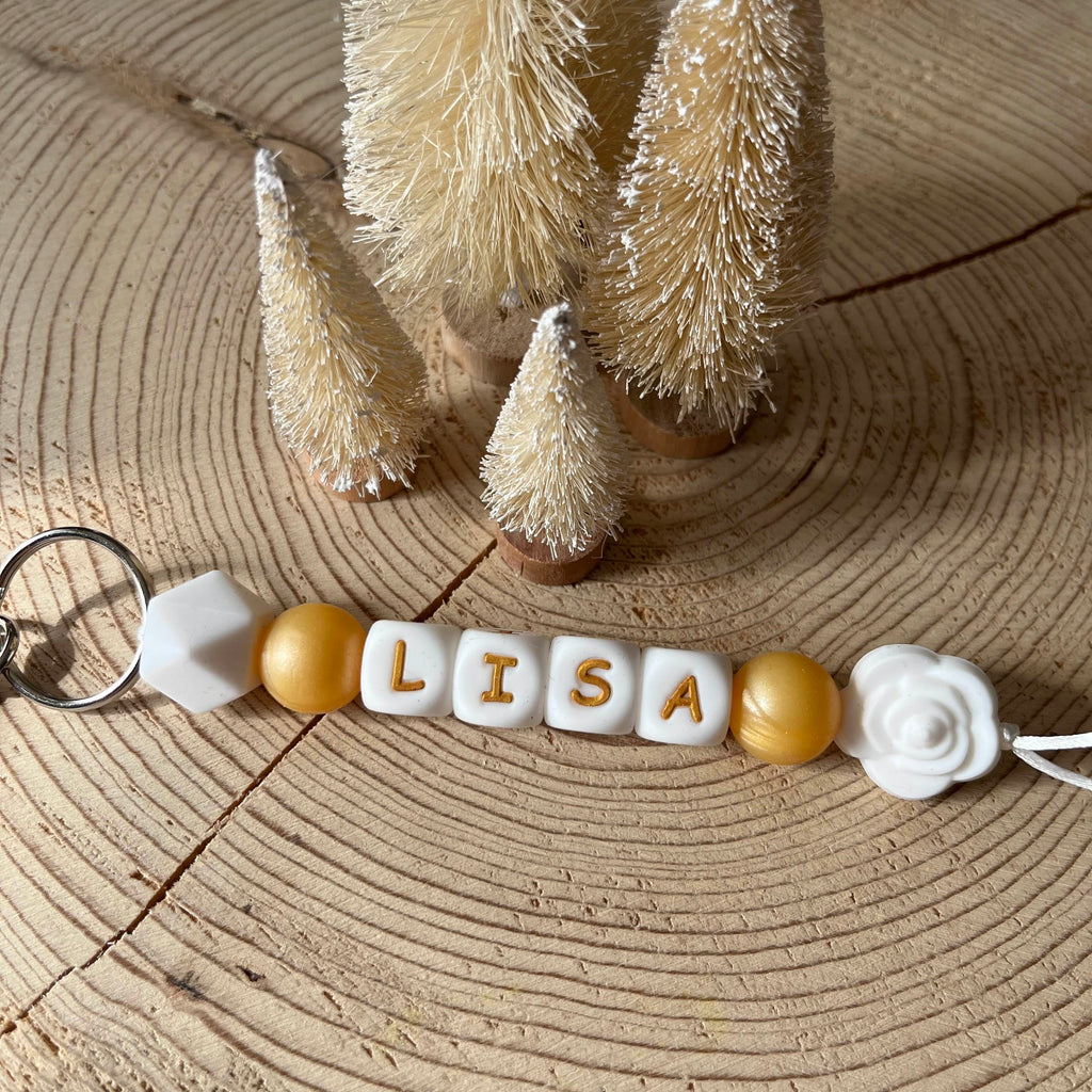 Porte-clés personnalisé en perles de silicone avec prénom jaune, blanc et fleur