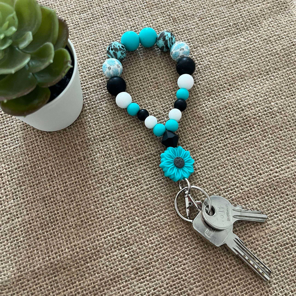 Porte-clés bracelet perlé turquoise & noir – Fleur décorative Ma boutique