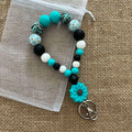 Porte-clés bracelet perlé turquoise & noir – Fleur décorative Ma boutique