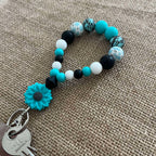 Porte-clés bracelet perlé turquoise & noir – Fleur décorative Ma boutique